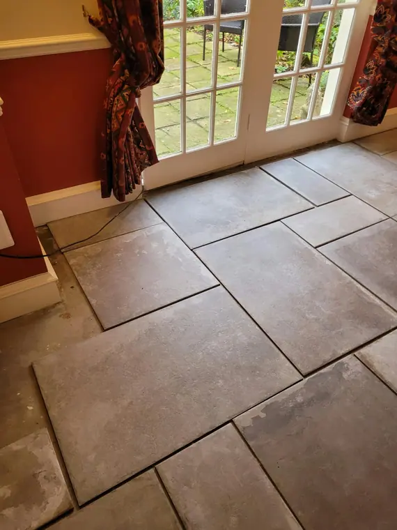 Tiles cut and laid tight to the garden doors.